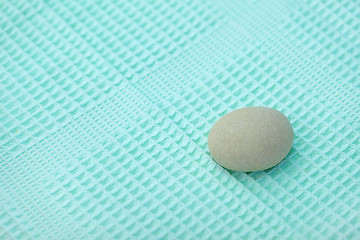 Image showing Pebble lying on towel - Spa background