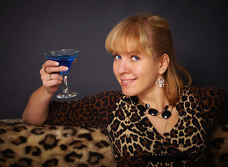 Image showing Beautiful young woman drinking blue cocktail