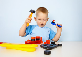 Image showing Little boy playing with toy tool