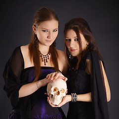 Image showing Two young girls with a human skull