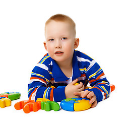 Image showing Little boy with color toys on white