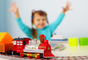 Image showing Happy child playing with railway