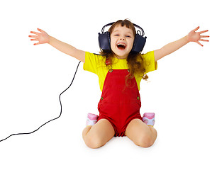 Image showing Happy girl listens to music with headphones