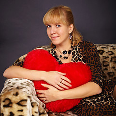 Image showing Beautiful young woman with toy heart in hands