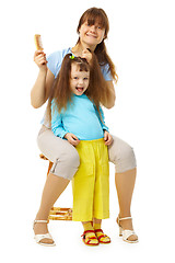 Image showing Cheerful mum and daughter do a hairdress