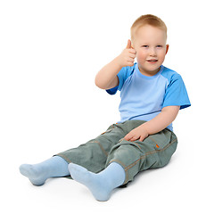 Image showing Little boy sits on white background showing a gesture