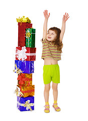 Image showing A child enjoys a lot of gifts for his birthday