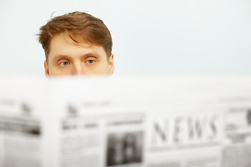 Image showing Young man reads the newspaper