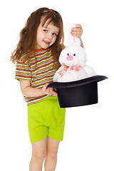 Image showing Child gets rabbit out of a hat like magician on white