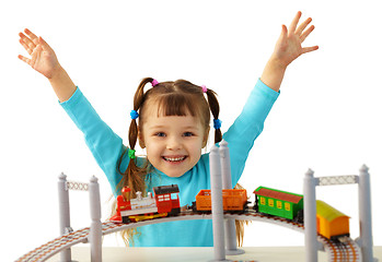 Image showing Joyful girl playing with toy railway