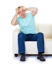 Image showing Nervous hysteria man at home on sofa isolated on white