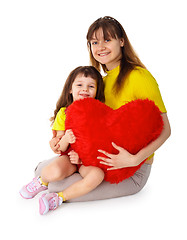 Image showing Mom and daughter with a toy heart in hands