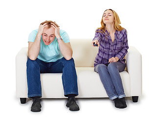 Image showing Nervous husband and wife sitting on couch watching TV