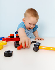 Image showing Child playing with a toy plastic constructor