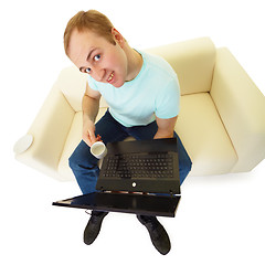 Image showing Emotional man with a laptop and a cup of coffee