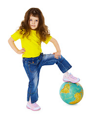 Image showing Little girl put her foot on geographic globe