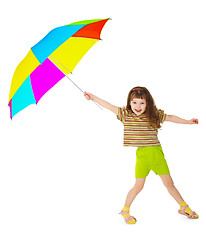 Image showing Little happy girl is playing with color umbrella