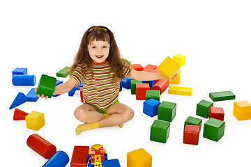 Image showing Little girl playing with color cubes on floor