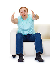 Image showing Man sits on couch in despair