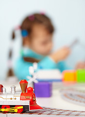 Image showing Child playing with toy railway