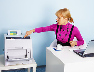 Image showing Young woman - secretary prints out a document