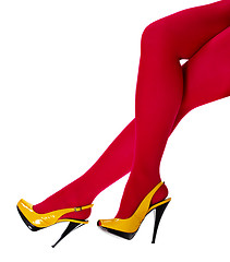 Image showing Beautiful female legs in yellow shoes and red tights