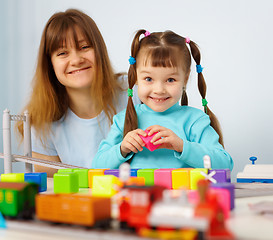 Image showing Mother and daughter playing with toys