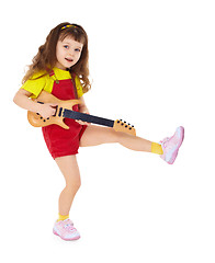 Image showing Little girl with toy guitar on white background