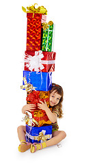 Image showing Little girl hugs birthday gifts