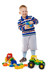 Image showing Child playing with toys on white background