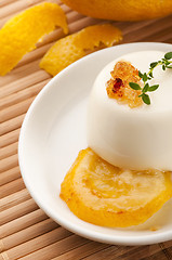 Image showing Vanilla Panna Cotta Dessert with lemon and fresh herbs