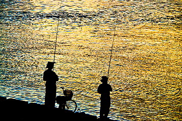 Image showing Fisherman silhouette  on shoreline