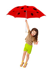 Image showing Little girl flying on red umbrella - ladybird