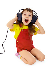 Image showing Cheerful little girl sings the music