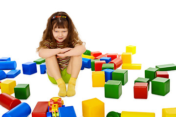 Image showing Angry little girl among the scattered toys