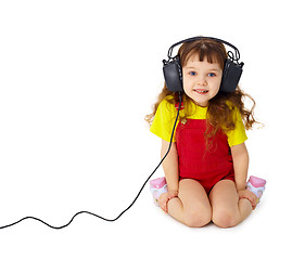 Image showing Child listens attentively to music on white