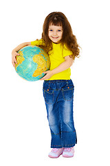 Image showing Cheerful little girl in jeans with a geographic globe