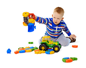 Image showing Little boy playing actively with plastic toys