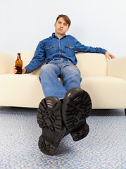 Image showing Drunk dude sprawled on couch