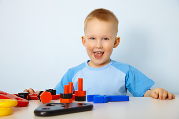 Image showing Happy little boy playing with toys