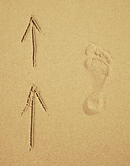 Image showing Trace of a human foot on sand. Tourist traffic.