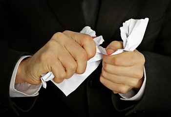 Image showing Businessman hands furiously tormenting document