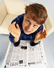 Image showing Man shocked by bad news from newspaper