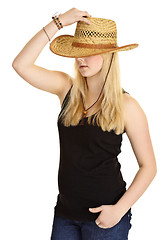 Image showing Young pale girl in old-fashioned straw hat