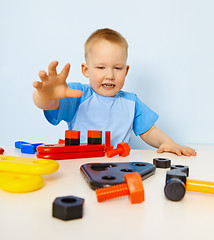 Image showing Funny kid playing with color parts