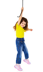 Image showing Cheerful little girl hanging on a rope