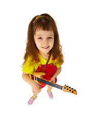 Image showing Funny little girl with toy guitar on white