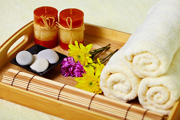 Image showing Tray of towels, candles and pebbles - spa