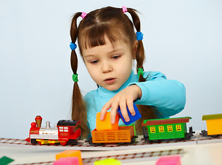 Image showing Little girl preschooler playing with toy railway