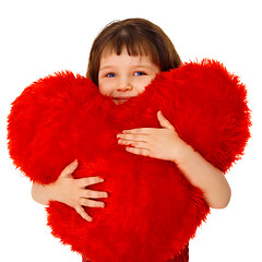 Image showing Little girl hugging a large toy heart